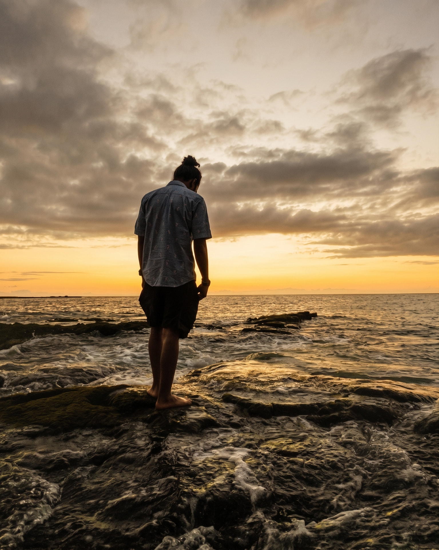 Shane Love standing on the shoreline at sunset