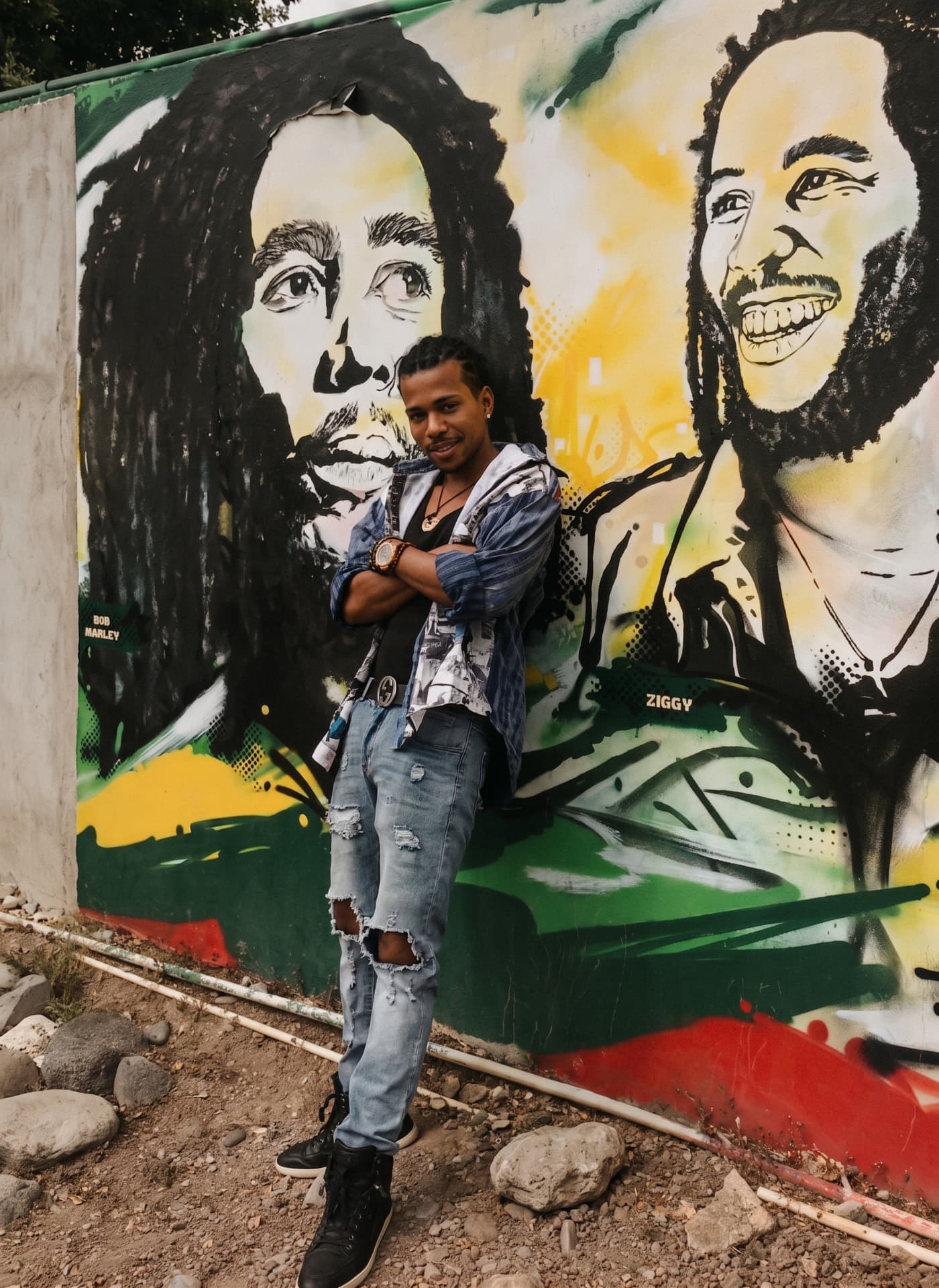 Shane Love leaning against a painted mural wall